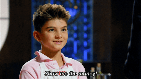 A smiling boy wearing a light pink polo shirt and a white apron says, “Show me the money!” in white text at the bottom, highlighting the importance of captions for engaging social media posts.