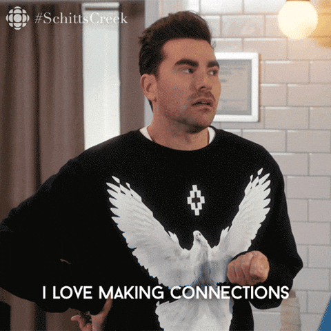 A man in a black jumper with a white bird design gestures with his hands and says, I love making connections. Perfect for anyone interested in creating shareable content. Text overlay and #SchittsCreek in corner.