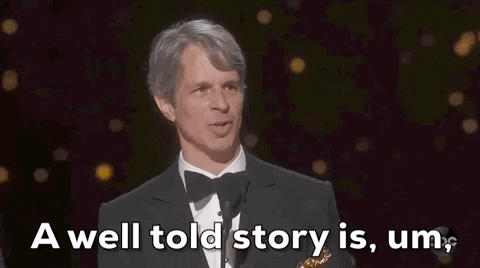 A man in a tuxedo speaks into a microphone onstage, holding an Oscar. White text at the bottom reads, A well-told story is, um, a powerful storytelling tool.