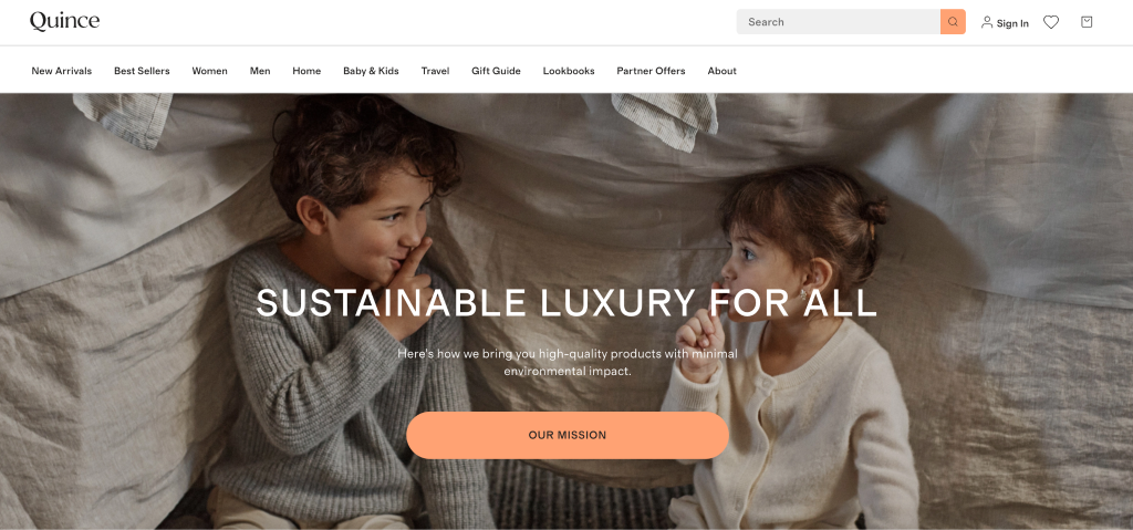 Two young children sit together in a cosy setting, smiling and playing under a beige blanket. The text overlay reads, “Sustainable Luxury for All.” An orange “Our Mission” button perfectly reflects thoughtful brand website design.