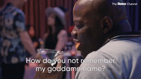 A man holding a drink speaks animatedly, with the caption “How do you not remember my bloody name?” visible at the bottom—an all-too-familiar scene at social gatherings, and a relatable moment for anyone lost in endless PR Pitches. Others are blurred in the background.